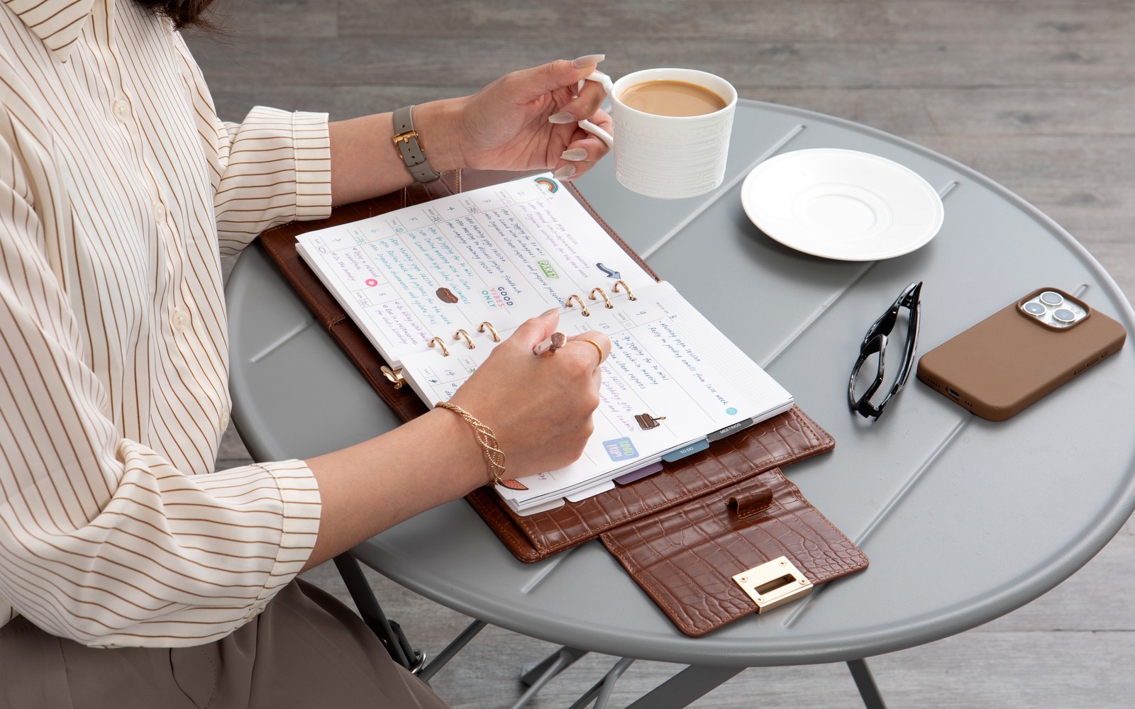 The Croco planner closed on a desk, showing crocodile emboss and a clean clutch silhouette