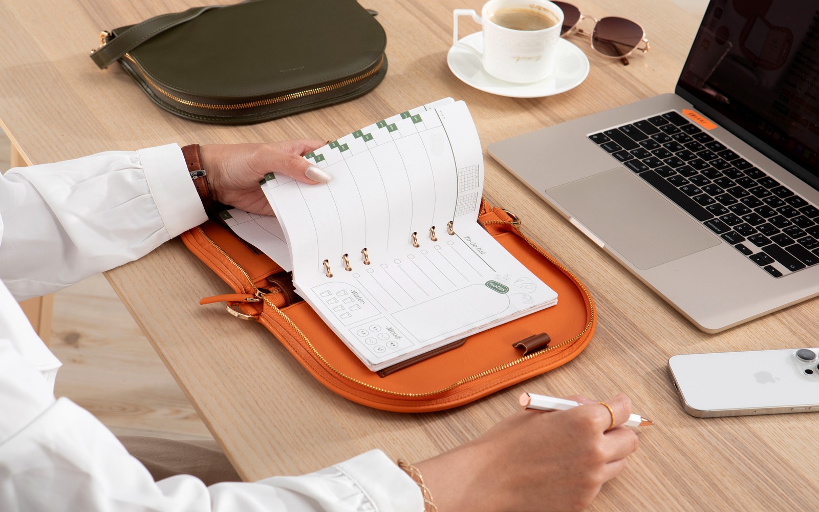 The Luna half-moon planner carried as a shoulder companion