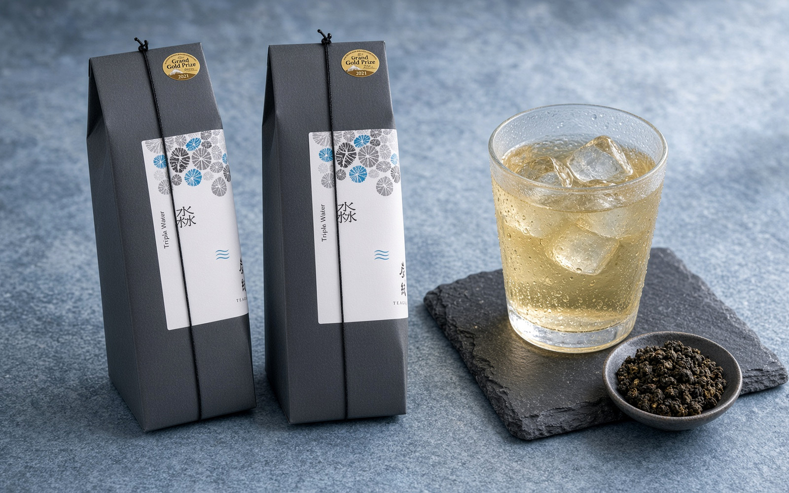 Cangui Guyun Miao (Water) whole-leaf sachet box with a glass of pale golden oolong
