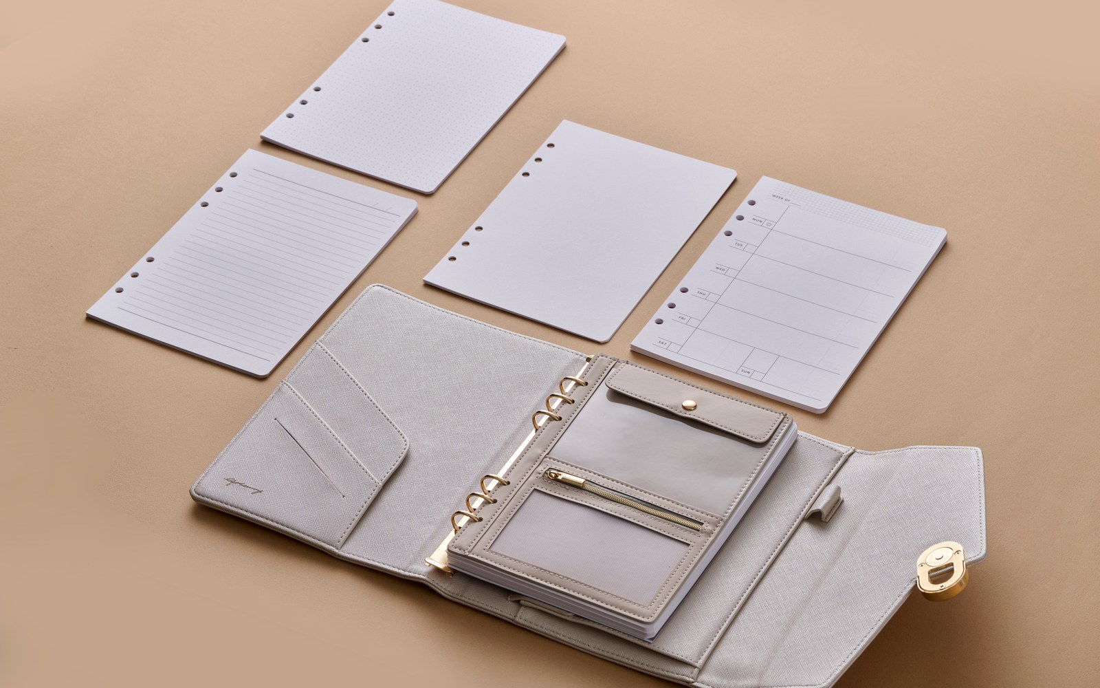 L’Éclair planner laid flat with fresh pages around it