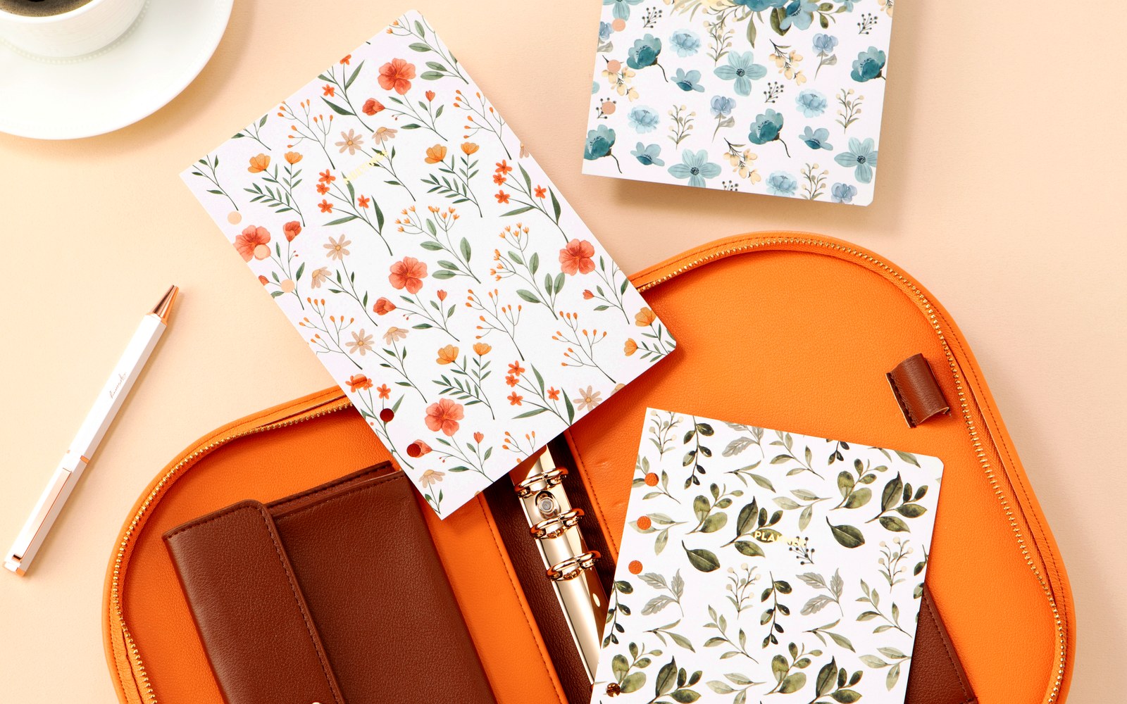 Floral inserts beside an open Luna planner