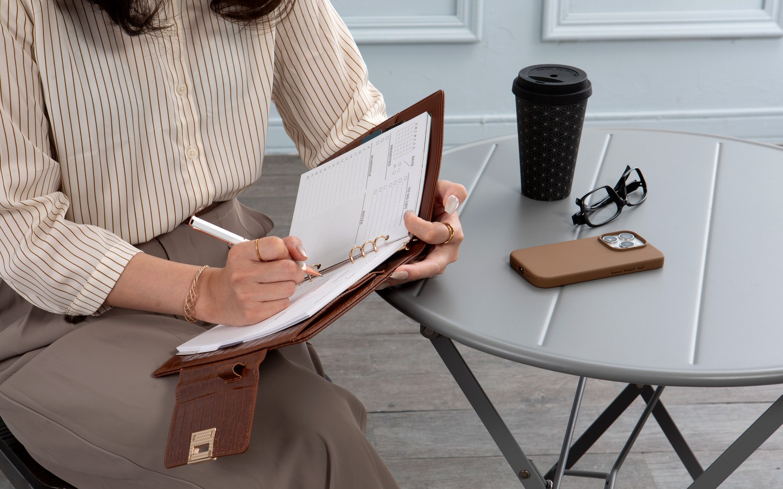 Planning at a café table with an EGOSUNNY planner and coffee