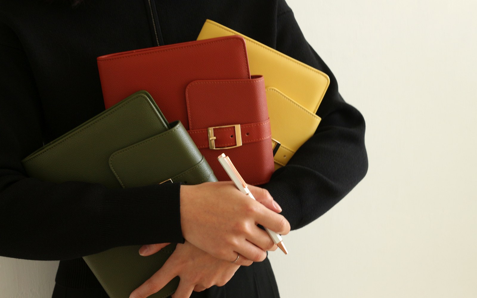 Holding EGOSUNNY planners while jotting a quick note
