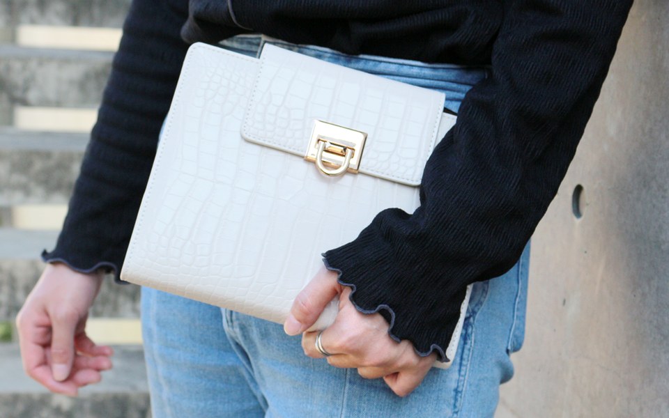 Woman in jeans holding a white EGOSUNNY Croco planner