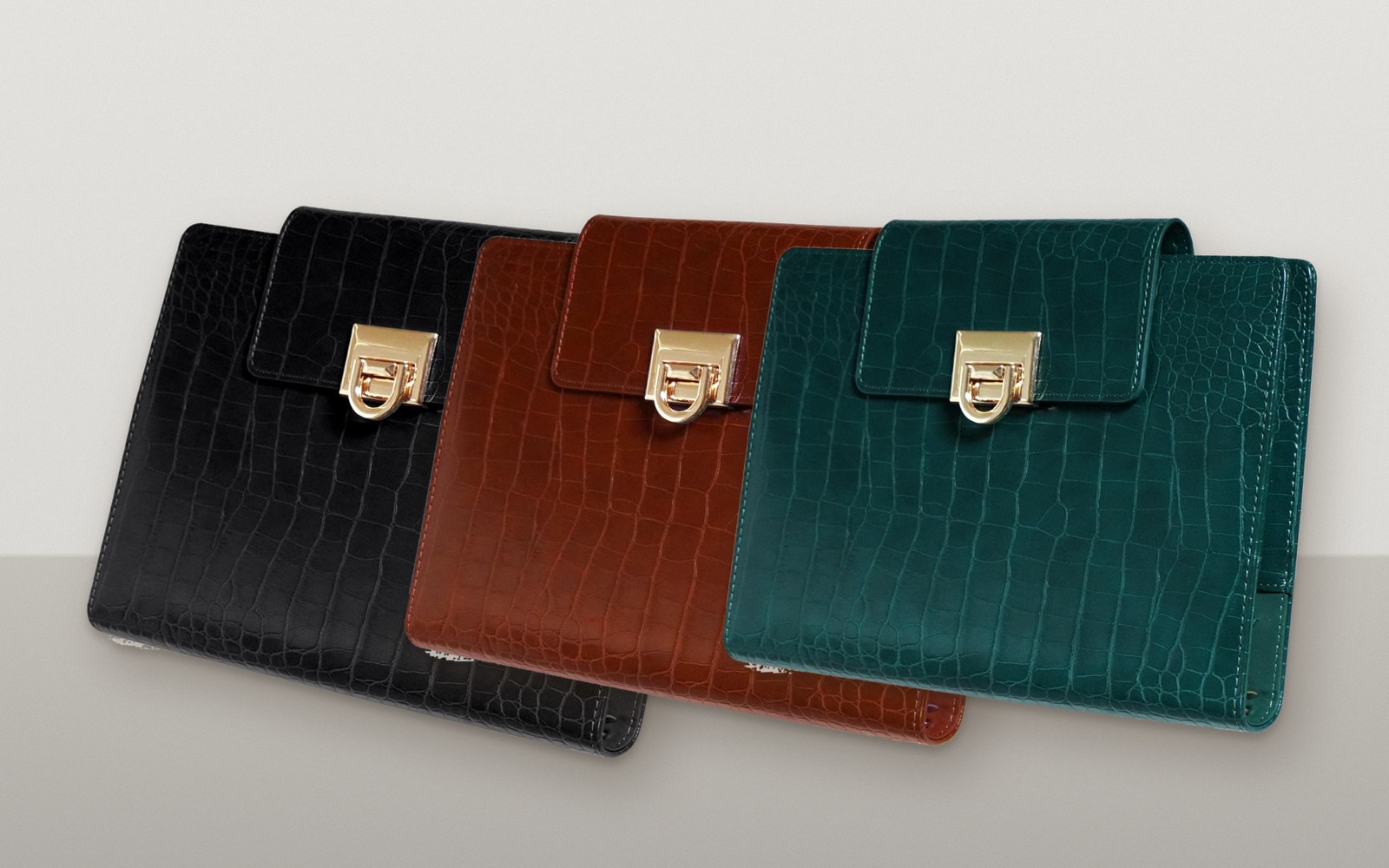 Black, brown and green EGOSUNNY Croco planners in a row