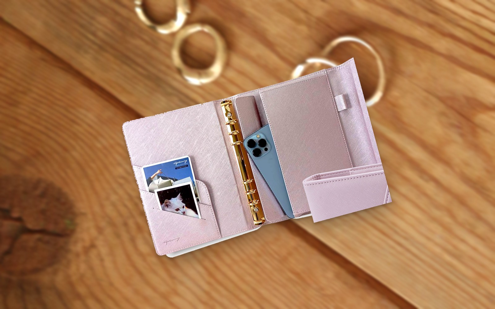 Open lilac EGOSUNNY L’Éclair planner with a photo on a wooden table