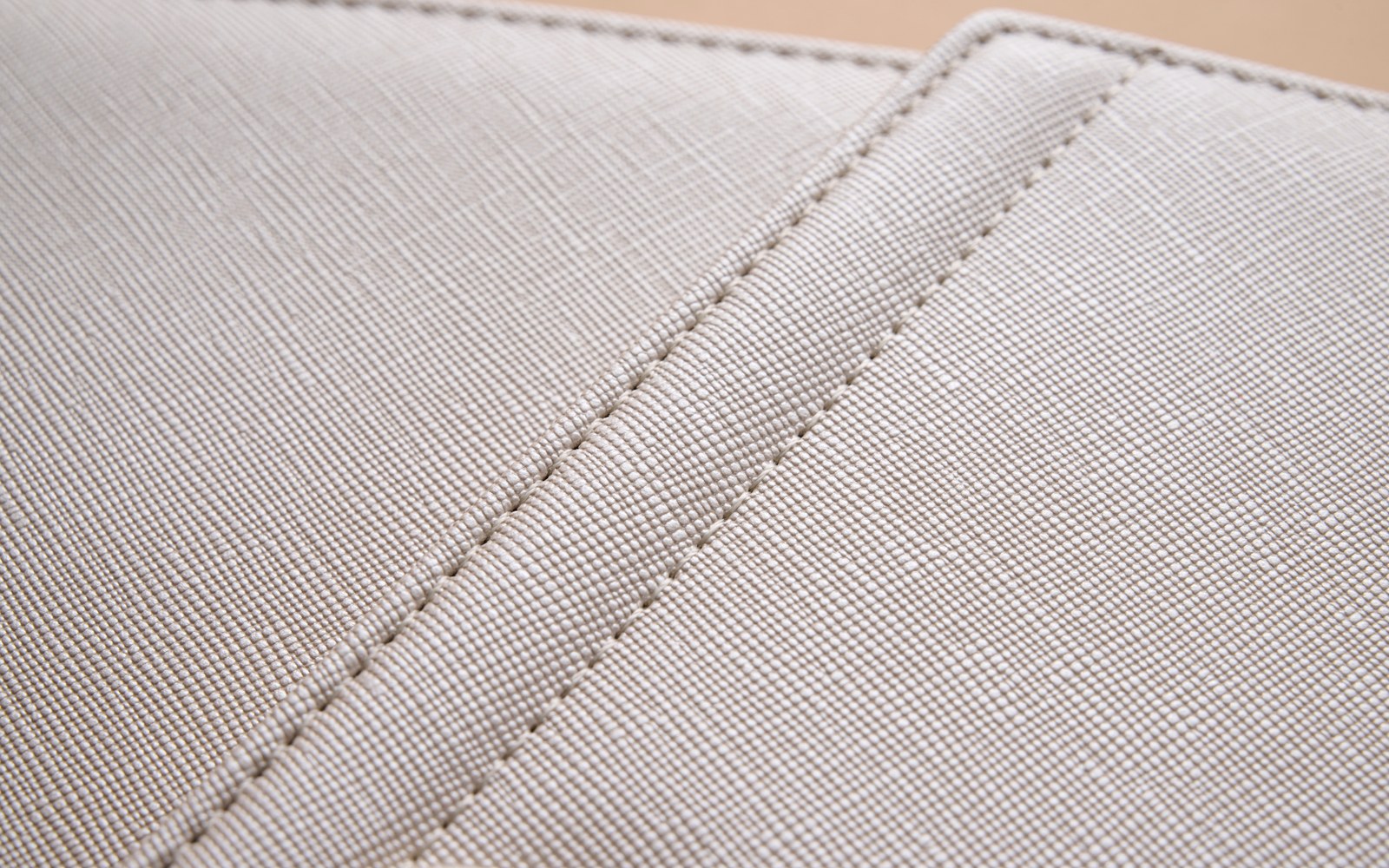 Close-up of the stitched, textured cover of an EGOSUNNY L’Éclair