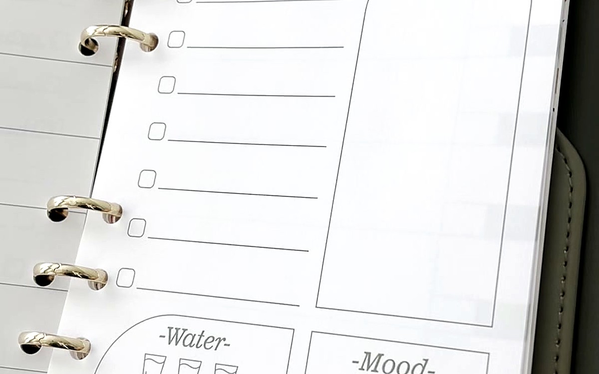 Clean to-do refill page with trackers inside silver rings