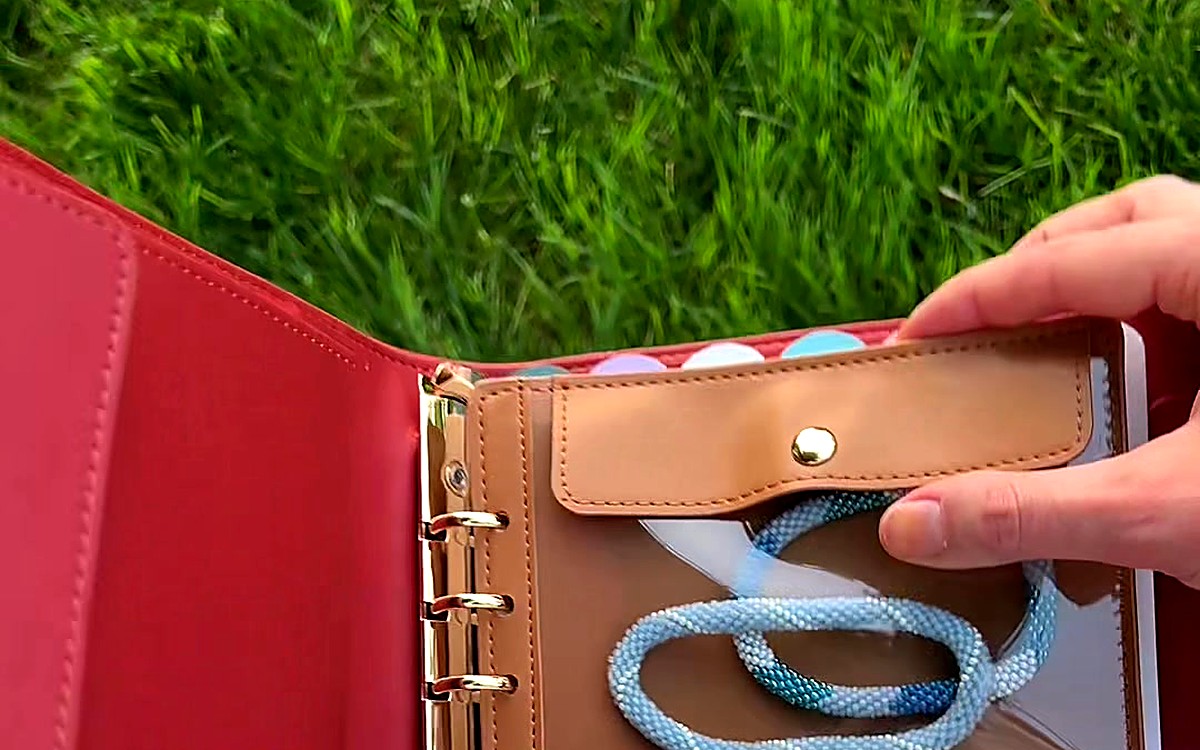 Snap pocket inside an open red EGOSUNNY Belt planner