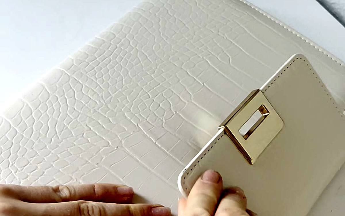 Hands opening a cream crocodile-texture EGOSUNNY binder