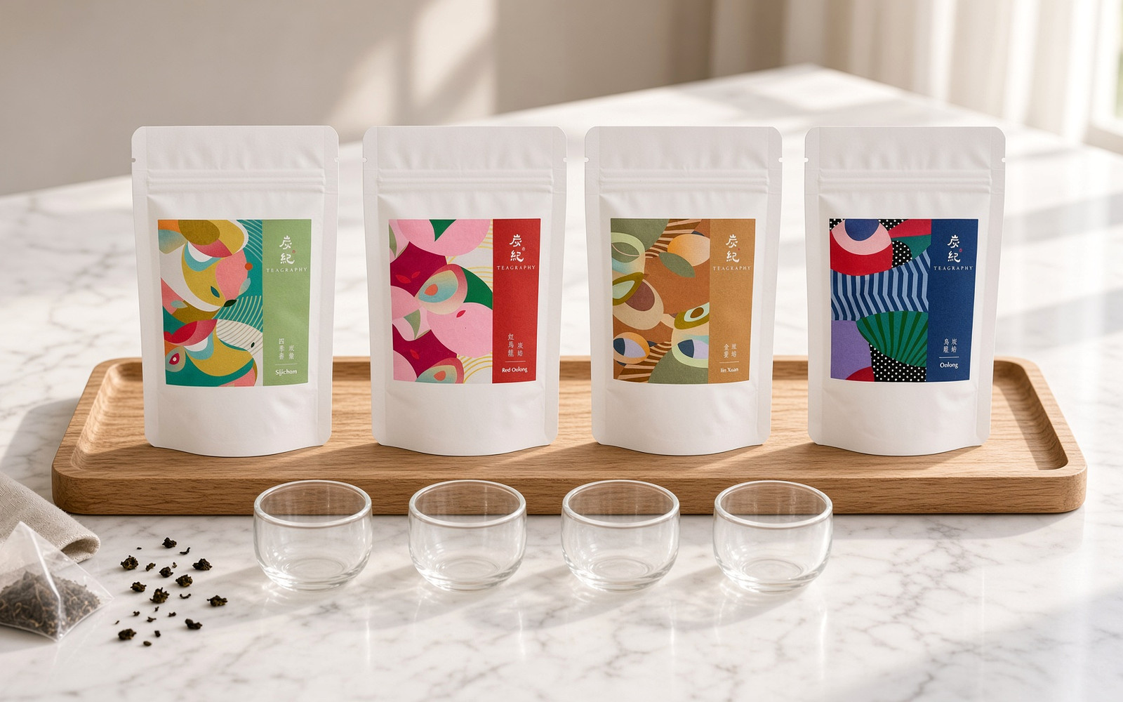 Four TEAGRAPHY Four Seasons oolong tea bag pouches laid out for a beginner tasting