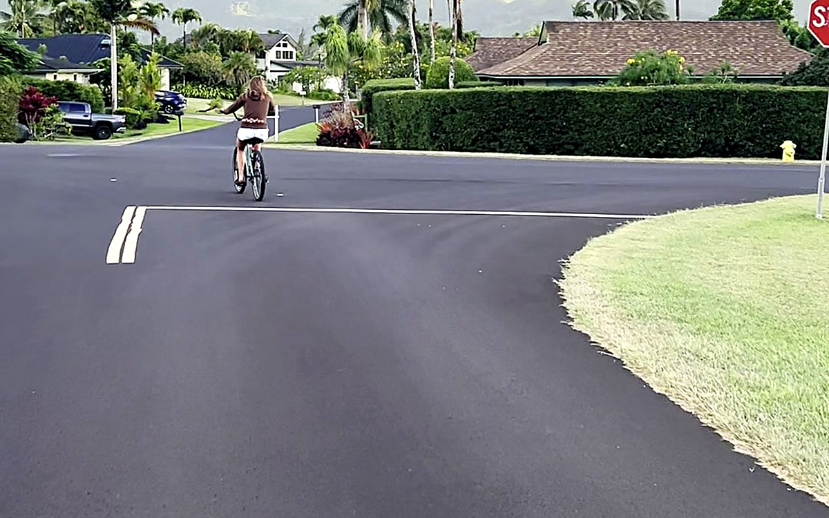 Woman riding a bike on a quiet road
