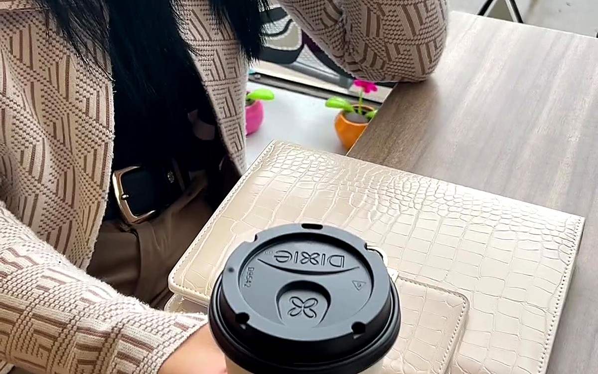 Coffee cup and planner on a café table