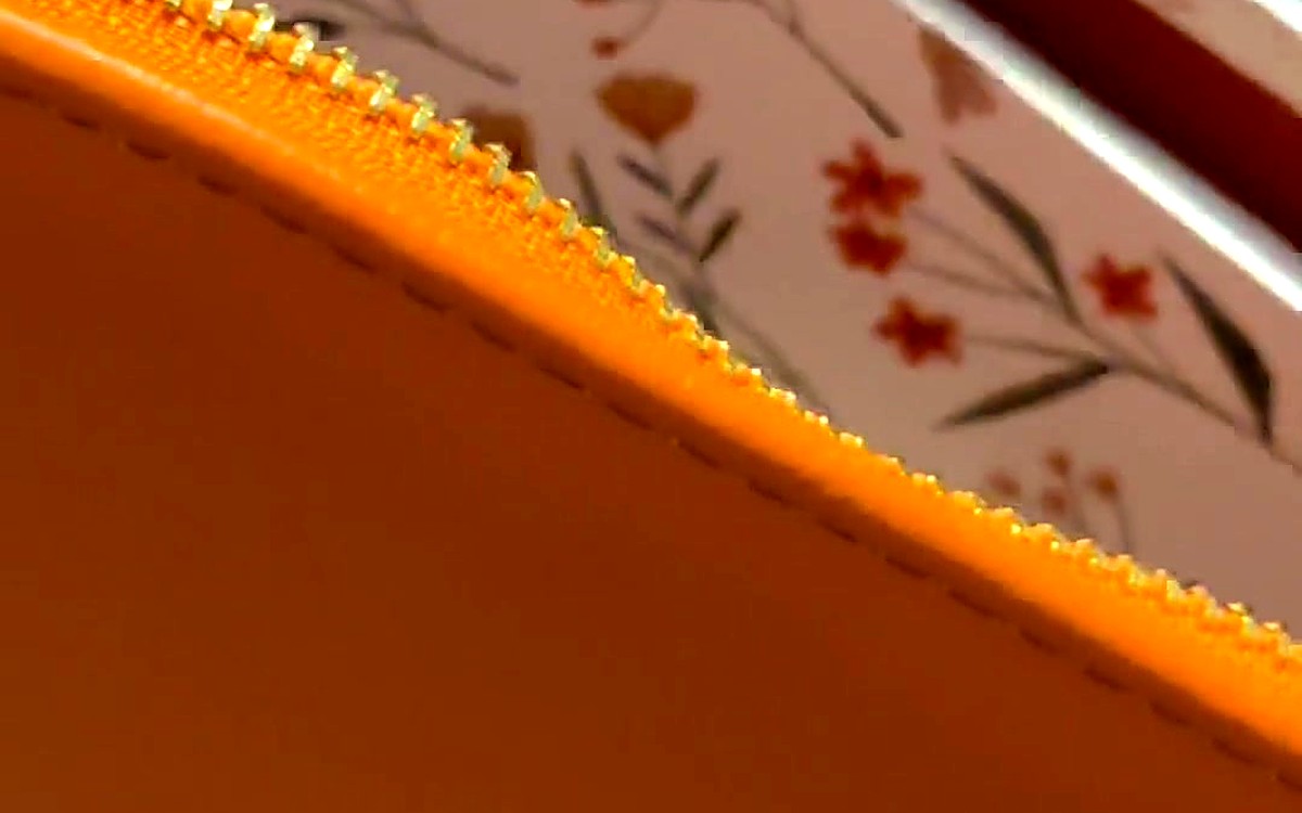 Floral refill page tucked inside an orange EGOSUNNY planner
