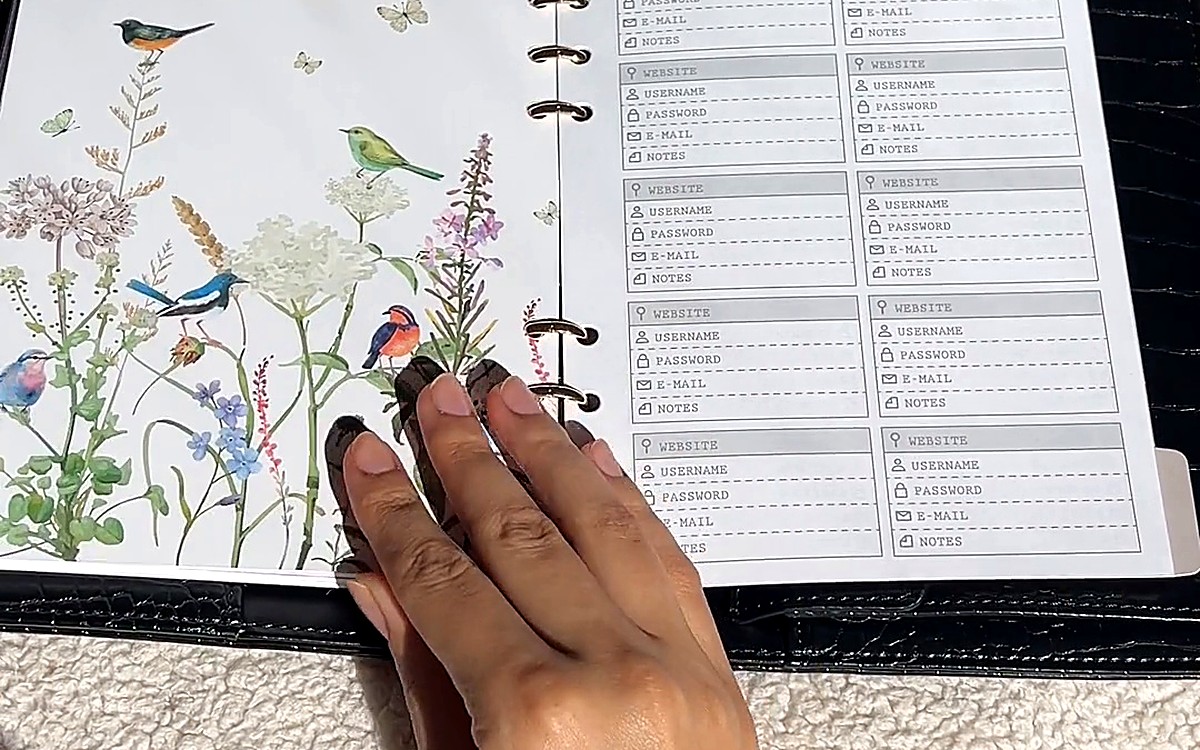 Hand on a floral planner page with schedule lines