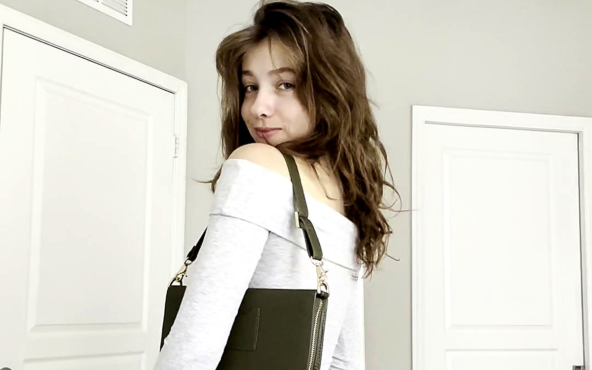 Woman looking over her shoulder with a black planner bag