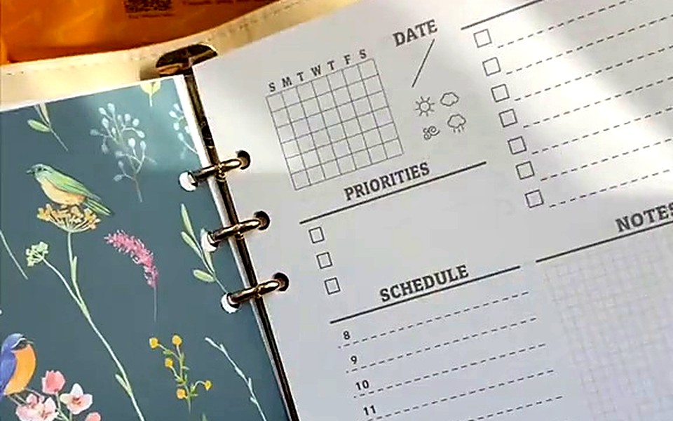 Floral cover beside a weekly planning page